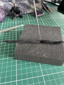 poke the needle into the wool and foam to make a custom Sleep Token figurine