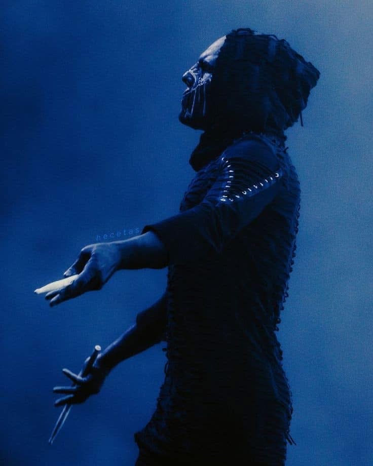 ii pointing his drumsticks at something