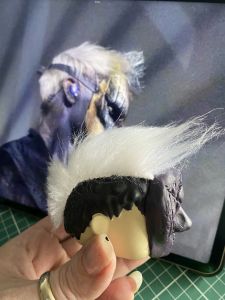 white fur stuck to a figure head to make a custom Sleep Token figurine