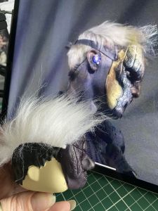 white fur stuck to a figure head to make a custom Sleep Token figurine