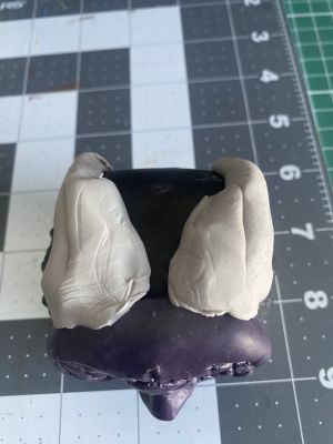 sculpting iii's hair on a custom Sleep Token figurine