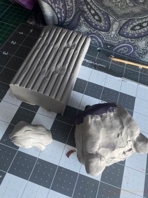 sculpting iii's hair on a custom Sleep Token figurine