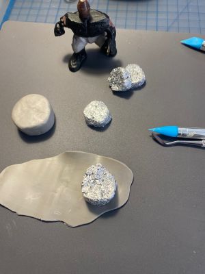 covering foil drum forms with clay for custom Sleep Token figurine