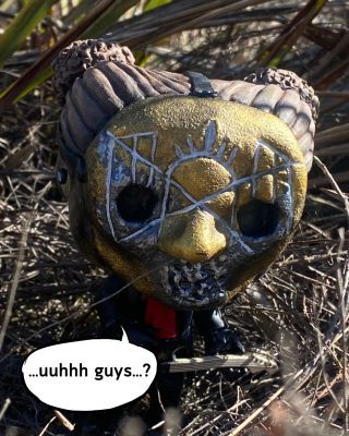 figurine of iii in the wilderness saying "Hey guys?"